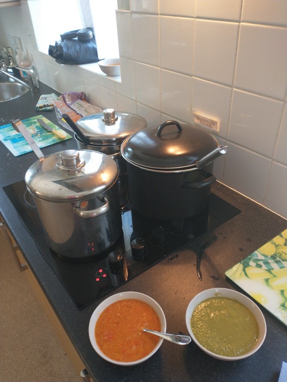 image of hob with saucepans full of soup and two bowls next to it full of soup